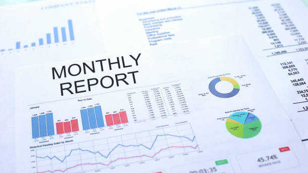 istock Monthly report lying on table, graphs charts and diagrams, official document 1144493979