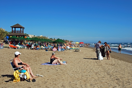 Tourists relaxing on Playa de la Vibora beach, Elviria, Marbella, Malaga Province, Andalusia, Spain, Western Europe.