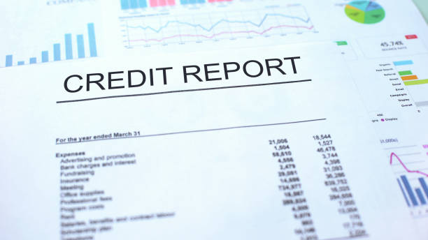 istock Credit report lying on table, graphs charts and diagrams, official document 1144494275