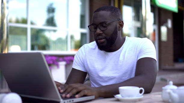 istock Concentrated student working on university project using laptop, sitting in cafe 1144494442