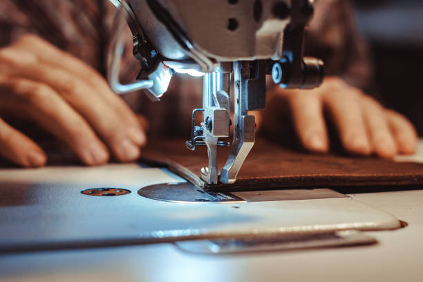 man sews leather on a sewing machine - sewing foot imagens e fotografias de stock