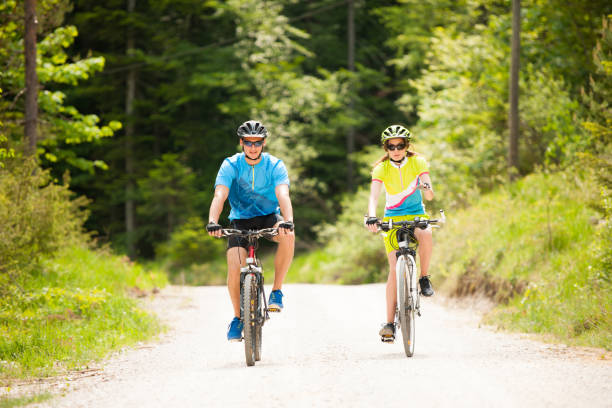 istock ACTIVE Young couple biking on a forest road in mountain on a spring day 1144497518
