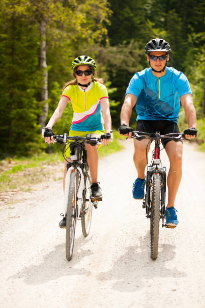 istock ACTIVE Young couple biking on a forest road in mountain on a spring day 1144497520