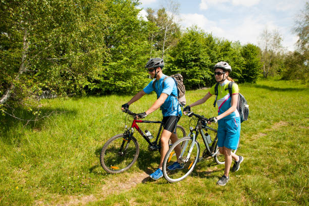 istock ACTIVE Young couple biking on a forest road in mountain on a spring day 1144497540