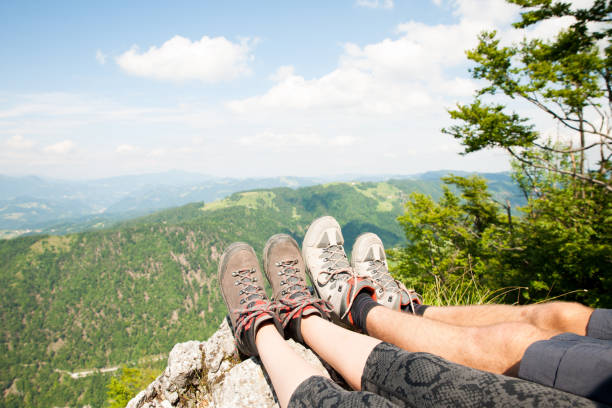 istock Mountain view over women legs as she rests on mountain peak 1144497666