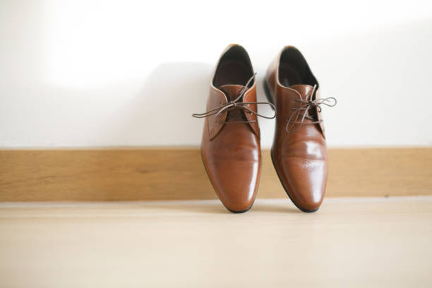 istock Brown leather show for bridegroom on white wall 1144498561