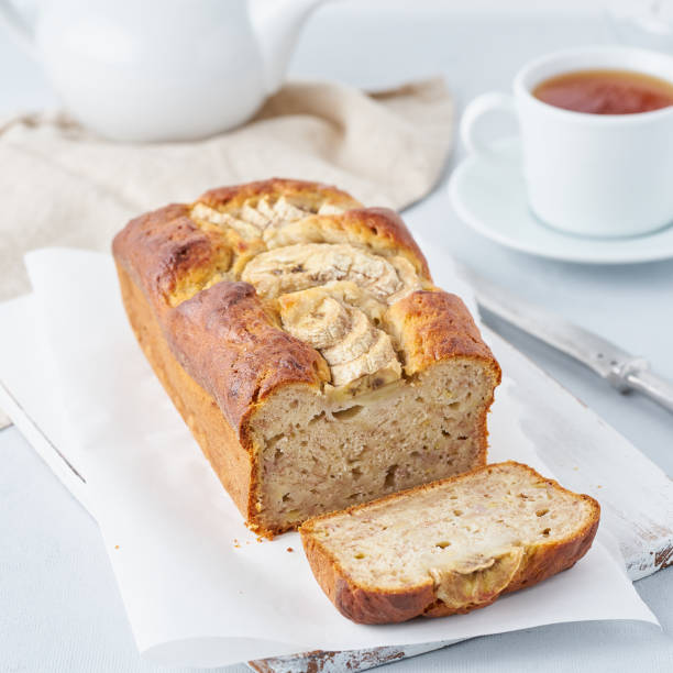 istock Banana bread, cake with banana, side view, vertical. The morning Breakfast with tea on a light grey background 1144501747