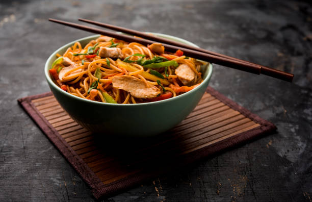 istock Chicken Hakka/Schezwan noodles served in a bowl with chopsticks. selective focus 1144501848