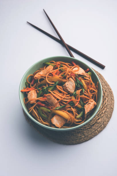 istock Chicken Hakka/Schezwan noodles served in a bowl with chopsticks. selective focus 1144502278