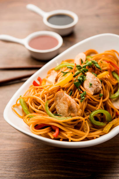 istock Chicken Hakka/Schezwan noodles served in a bowl with chopsticks. selective focus 1144503928