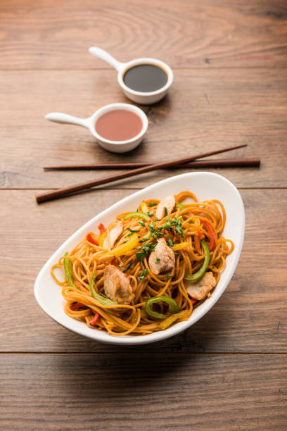 istock Chicken Hakka/Schezwan noodles served in a bowl with chopsticks. selective focus 1144504061