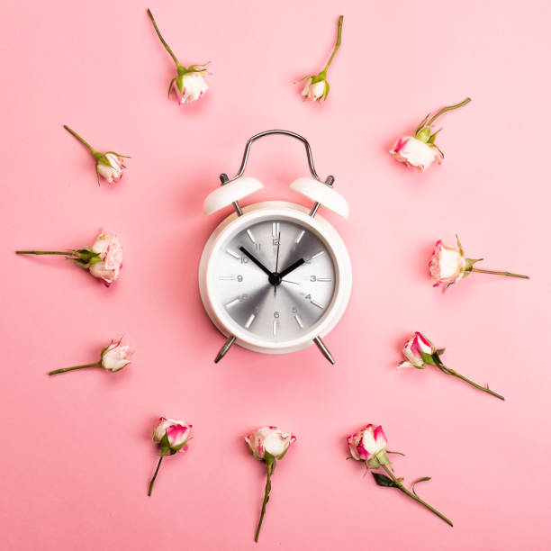 istock Retro white and silver alarm clock on a pink background 1144504178