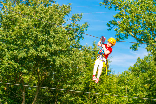 istock Little brave caucasian girl using a zip line. 1144504539