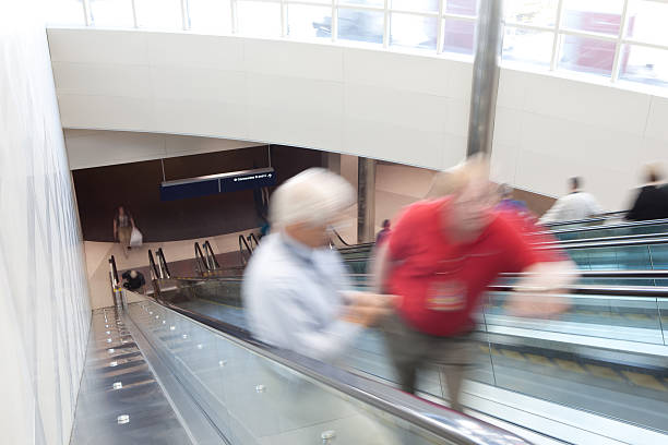 istock People in blurred motion standing on the escalator 114450490