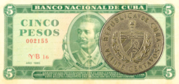 istock 20 cuban centavo coin against 5 cuban peso banknote 1144504977