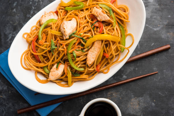 istock Chicken Hakka/Schezwan noodles served in a bowl with chopsticks. selective focus 1144505232