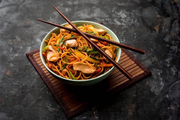 istock Chicken Hakka/Schezwan noodles served in a bowl with chopsticks. selective focus 1144505561