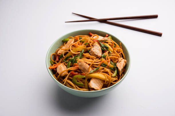 istock Chicken Hakka/Schezwan noodles served in a bowl with chopsticks. selective focus 1144505723