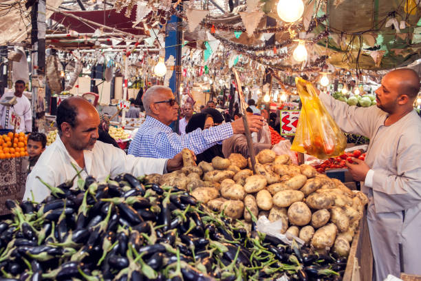 Haryana, India – December 26, 2017: Indian men selling raw vegetables at night in the market which is located in rohtak city of Haryana state, India.