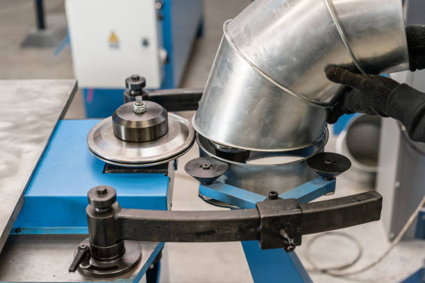 istock Worker controls the machine. Production rolling tool, electric machine. the production of ventilation and gutters. Tool and bending equipment for sheet metal. 1144507027