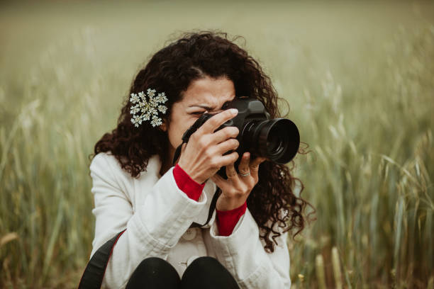 istock Woman Photographing Through Camera On Field 1144510262