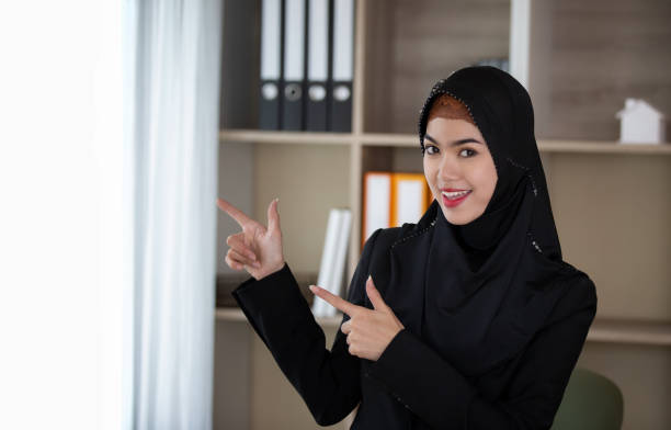 istock Smiling Young Businesswoman Wearing Hijab While Gesturing In Office 1144510554