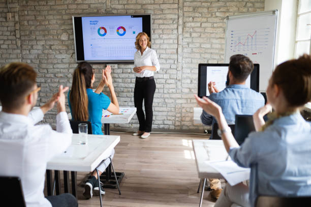 istock Successful happy group of people learning software engineering and business during presentation 1144511299