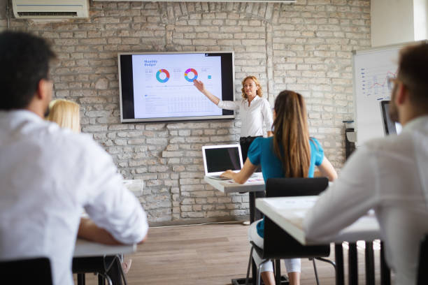 istock Successful happy group of people learning software engineering and business during presentation 1144511683