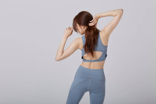 istock Asian girl wear exercise suit pose her back in studio 1144513172