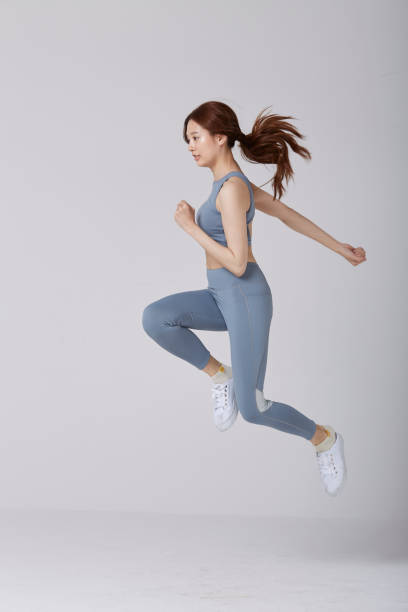 istock Selective motion focus of Asian girl wear exercise suit pose running in studio 1144513402