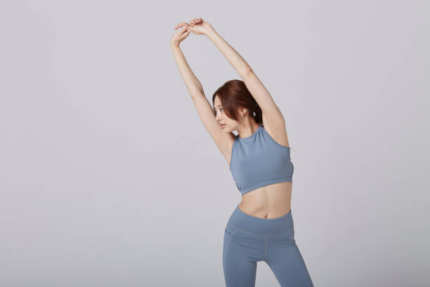 istock Asian girl wear exercise suit pose stretching in studio 1144513496