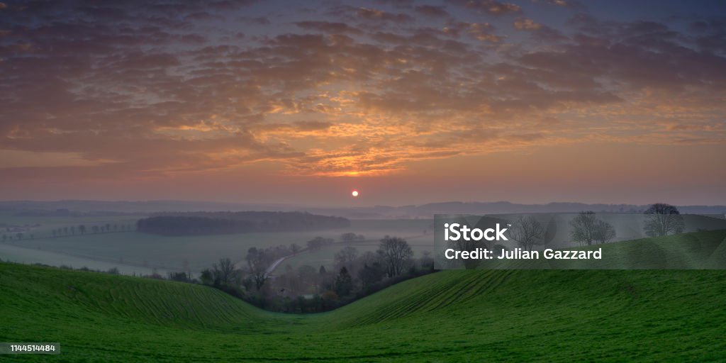 Spring sunrise over the South Downs near Hambledon, Hampshire, UK Hambledon,UK - March 30, 2019: Sunrise over Hambledon and the South Downs National Park, Hampshire, UK Autumn Stock Photo
