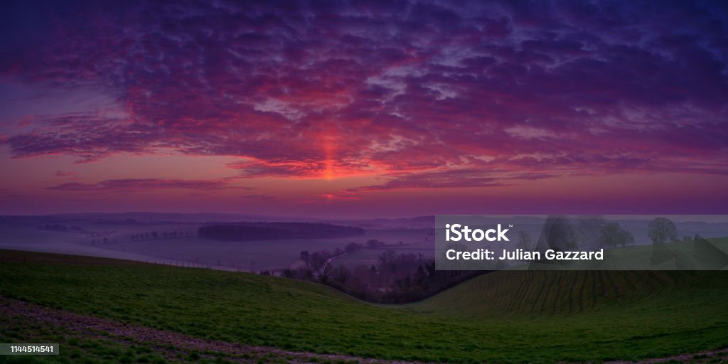 Spring sunrise over the South Downs near Hambledon, Hampshire, UK Hambledon,UK - March 30, 2019: Sunrise over Hambledon and the South Downs National Park, Hampshire, UK Autumn Stock Photo