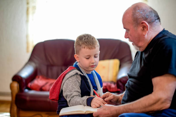 istock Grandfather drawing with his grandson 1144514686