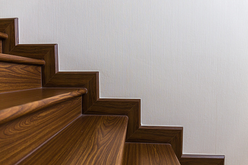 The wooden staircase leads to the basement.