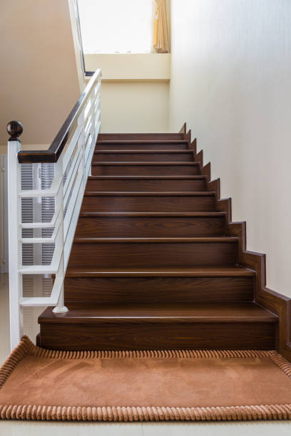 istock Staircase custom built home interior with wood staircase and white walls. 1144516365