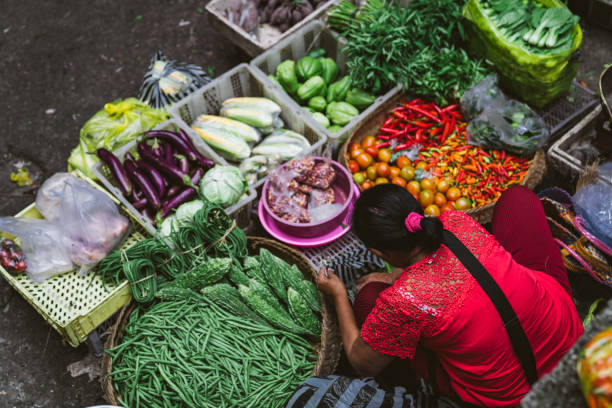 Vendor selling vegetables. Ubud market is located across from the old imperial palace on Jalan Raya Ubud, in the Town of Ubud. The market is a good place to buy fresh fruits, vegetables and souvenirs.