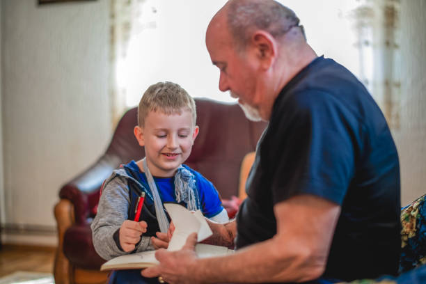 istock Grandfather drawing with his grandson 1144516669