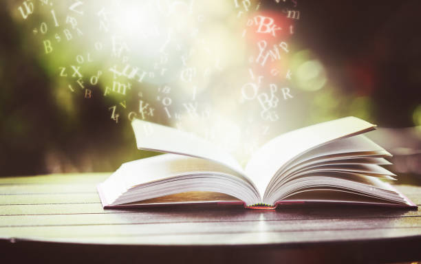 istock Misty letters float up from open book: words are magic 1144516771