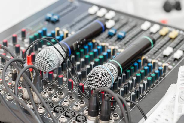 istock Microphone close-up. Focus on mic. Event concept. Music mixer equalizer console for mixer control sound device. Sound technician audio mixer equalizer control. 1144518446