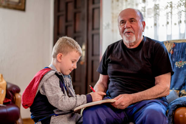 istock Grandfather and Grandson doing homework  together 1144519105