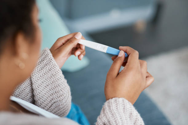 Half a minute has never felt so long Cropped shot of an unrecognizable woman taking a pregnancy test at home human fertility stock pictures, royalty-free photos & images