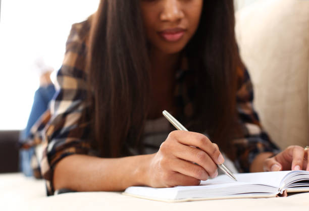 istock Arm of black woman write story in notebook 1144519998