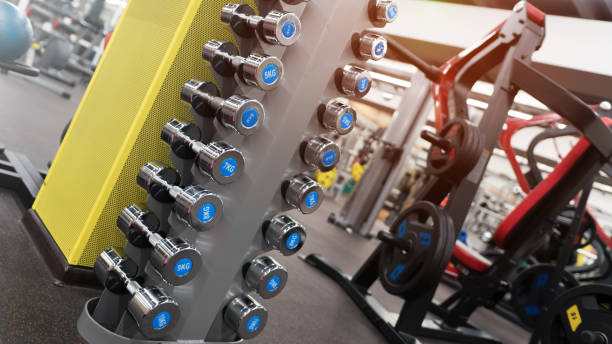istock Rows of new grey dumbbells in a rack 1144521320
