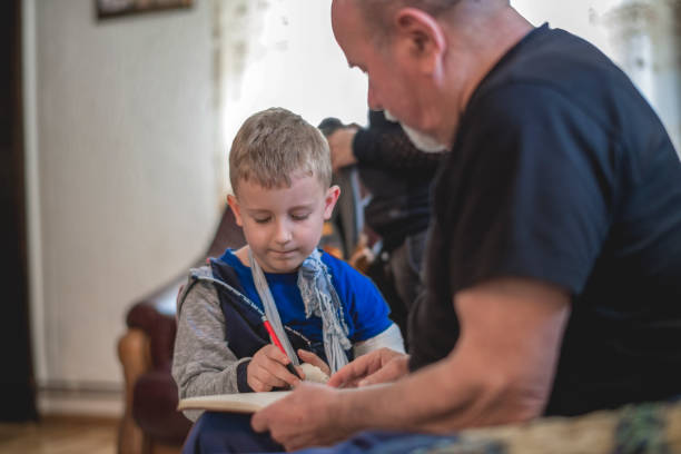 istock Grandfather helping grandson 1144522028