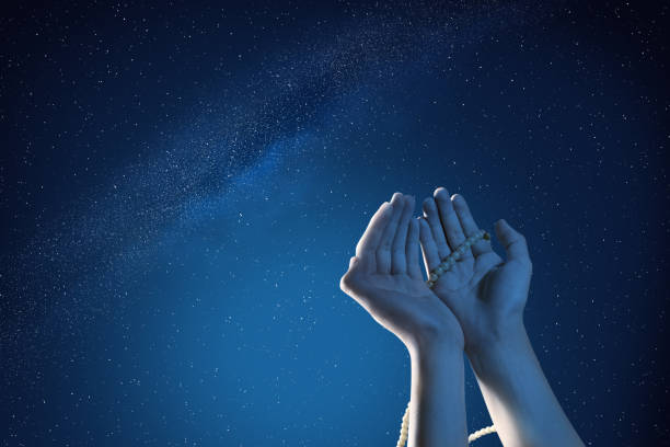 Muslim hands praying with prayer beads at outdoor Muslim hands praying with prayer beads at outdoor with night scene background allah photos stock pictures, royalty-free photos & images