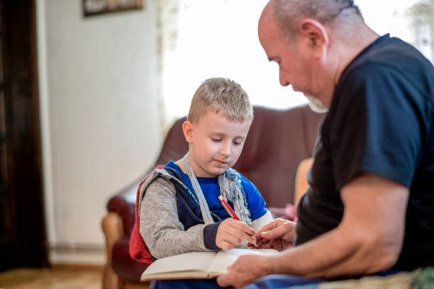 istock Grandfather drawing with his grandson 1144522516