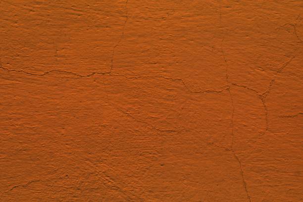 istock red broken plaster texture - fantastic abstract photo background 1144523039