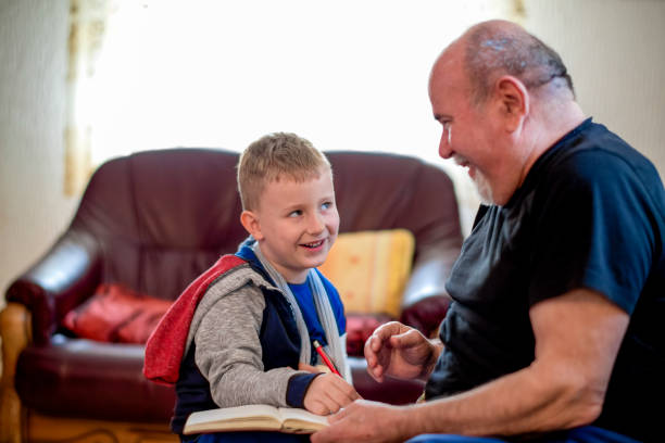 istock Grandfather drawing with his grandson 1144523076