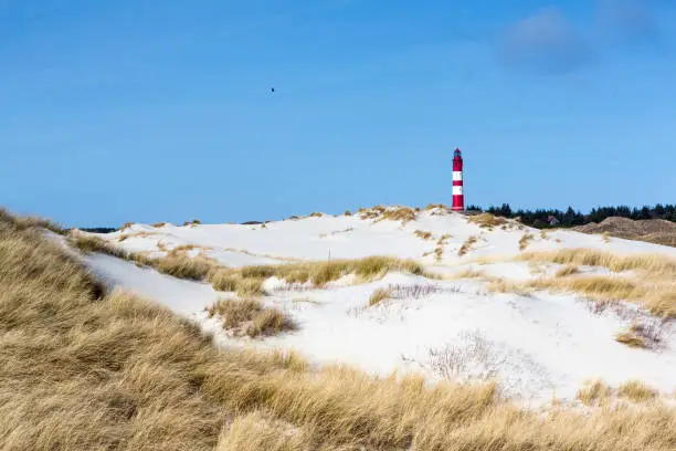 Photo of Red and white lighthouse on the hill